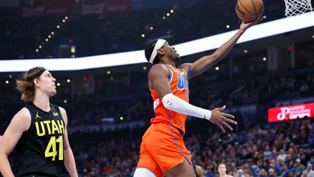 Dec 11, 2023; Oklahoma City, Oklahoma, USA; Oklahoma City Thunder guard Shai Gilgeous-Alexander (2) shoots ahead of Utah Jazz forward Kelly Olynyk (41) during the second quarter at Paycom Center